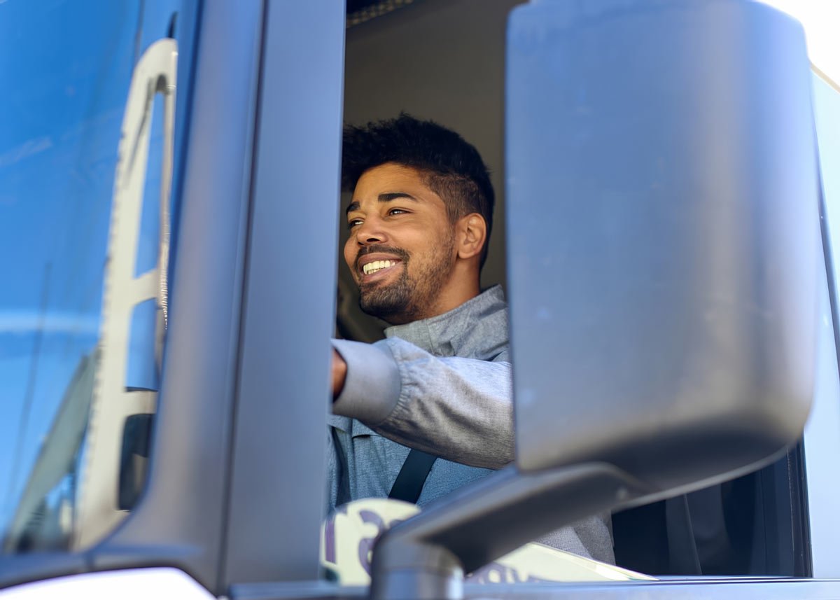 man sitting in truck smiling man sitting in truck smiling