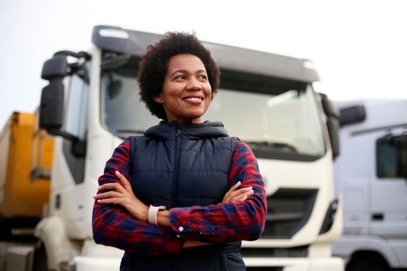 woman-standing-in-front-of-white-semi-truck woman-standing-in-front-of-white-semi-truck